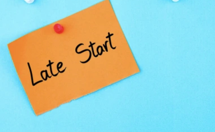 An orange sticky note with the text "Late Start" pinned against a light blue background.